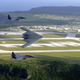 American F-15E Strike Eagles fly alongside a B-2A Spirit Stealth bomber over Andersen AFB on the island of Guam. USAF Photo